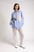 Women's oversized shirt with crochet flower appliqué